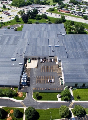 an aerial view of a large building with a parking lot