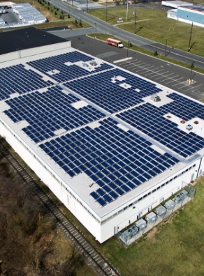 a large building with a lot of solar panels on the roof