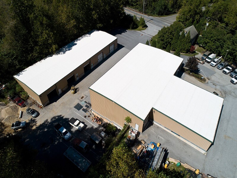 an aerial view of a building with a plain white roof