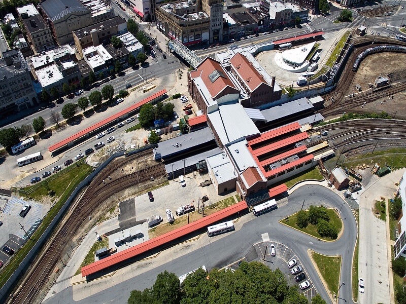 an aerial view of a train station in a city